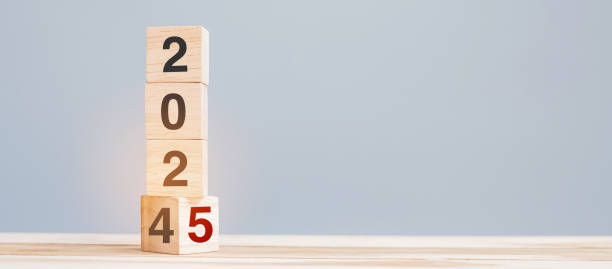 istock 2024 chang to 2025 wooden cube blocks on table background. Resolution, plan, review, goal, start, end year  and New Year holiday concepts 2153754064