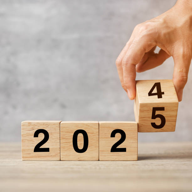 istock hand flipping block 2024 to 2025  text on table. Resolution, strategy, plan, goal, motivation, reboot, business and New Year holiday concepts 2153754077