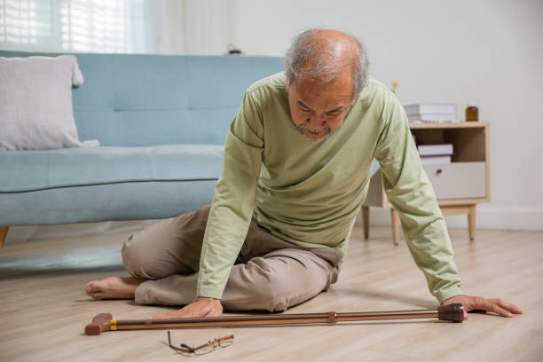 istock Sick senior old man falling down lying on floor because stumbled at home 2153756773