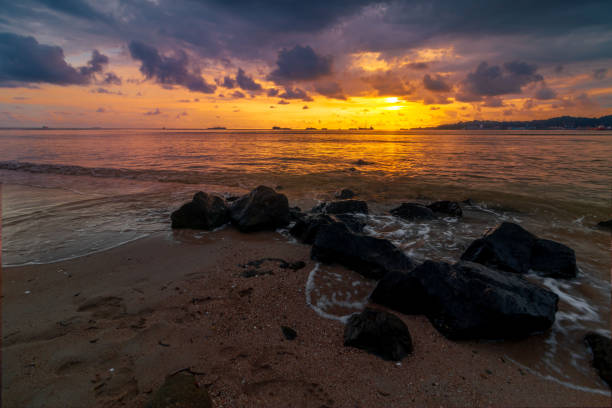 istock sea at sunset with rocks and clouds 2153757348