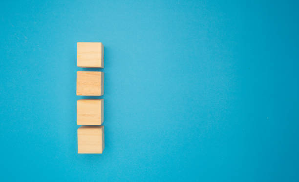 Four wooden cubes are on a blue background.