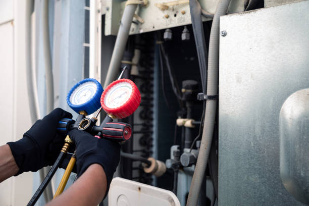 Air conditioning, HVAC service technician using gauges to check refrigerant and add refrigerant,Air Conditioning Repair, repairman on the floor fixing air conditioning system.