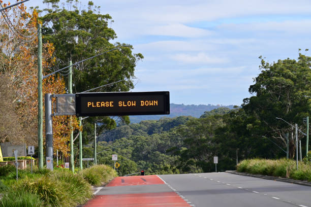 Please slow down sign Central Coast New South Wales Australia – May 20, 2024 Road safety sign saying please slow down speed limit sign australia stock pictures, royalty-free photos & images