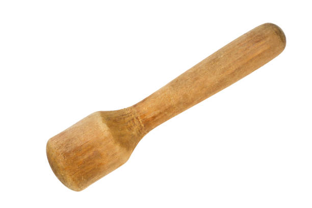 Antique wooden pestle on a white background.