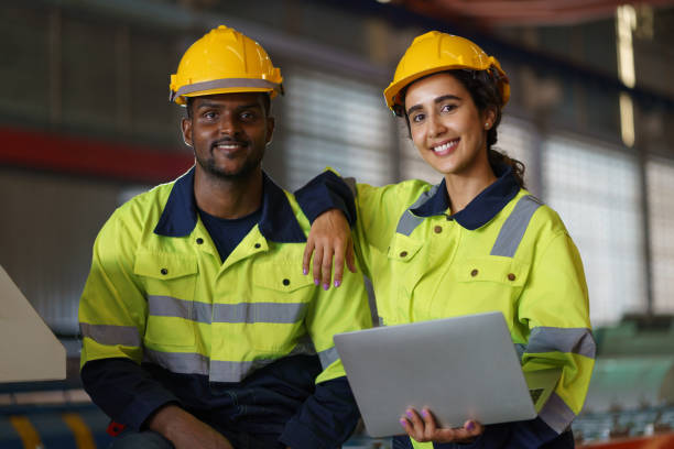 istock Engineer, Workers in a busy warehouse engage in various tasks, showcasing a collaborative team effort in an industrial setting, with a focus on safety and efficient work practices 2153764445