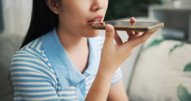 istock Close up,Young woman talking on her smartphone using the speakerphone at home. 2153766111