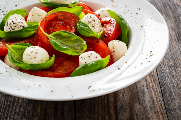 istock Caprese salad in white bowl on wooden table 2153768522