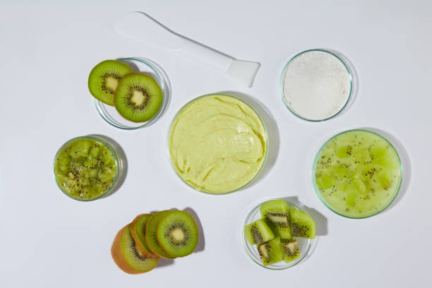 istock A dish containing yellow exfoliating scrub placed in center, surrounded by some dish of fresh kiwi over white texture. Photo from above view with empty space for advertising 2153768726