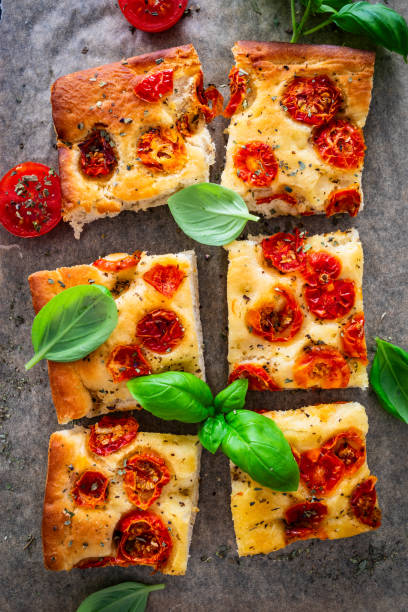 istock Focaccia - roasted mozzarella sandwiches with ham, tomatoes and arugula on black stone plate 2153768742