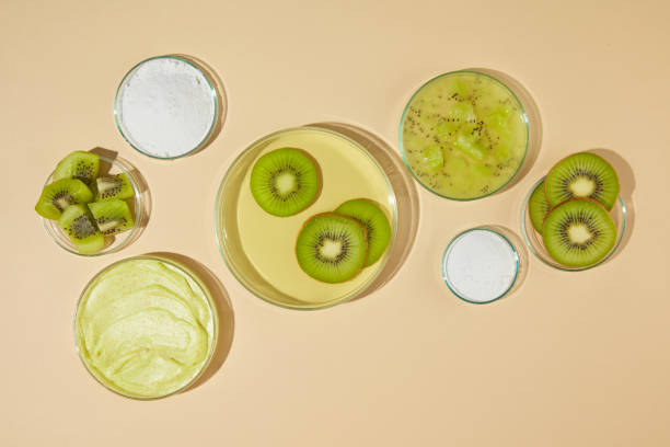 istock Plenty glass dishes displayed on light yellow counter top, a blank dish in center with some kiwi slices above, next to it are some dishes of exfoliating cream and fresh kiwi. Template for designing 2153769122