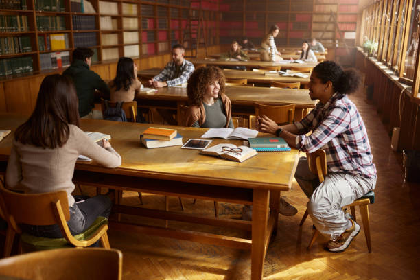 istock Large group of college students learning together in library. 2153769254