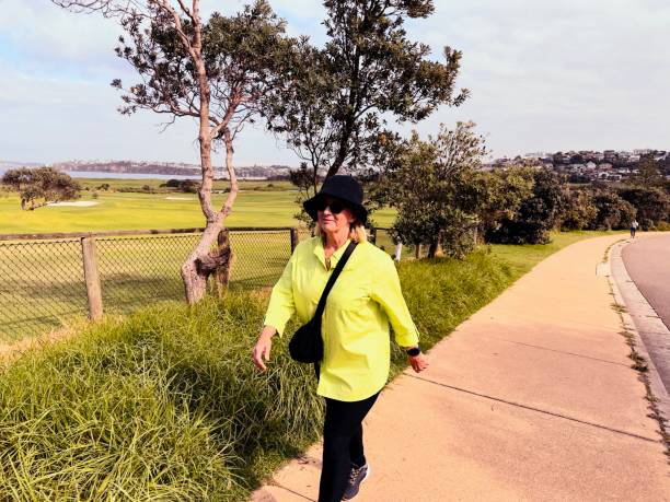 istock Senior female walking along a path near the coast 2153769854