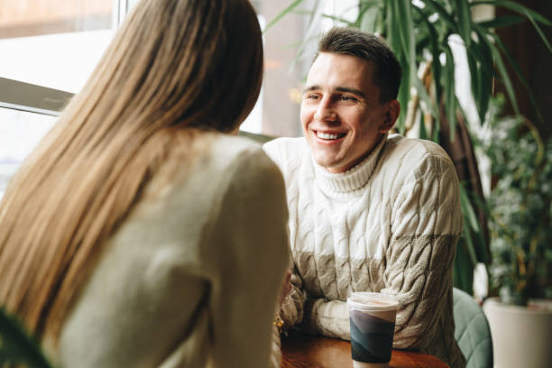 istock Smiling Man Engaged in a Casual Conversation at a Cozy Cafe During Daytime 2153769894