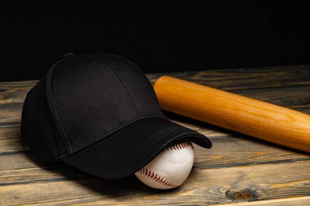 istock Baseball cap, ball and bat on wooden background 2153770330