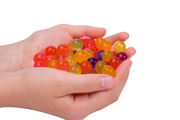 istock Water coloured gel balls on hand. 2153770713