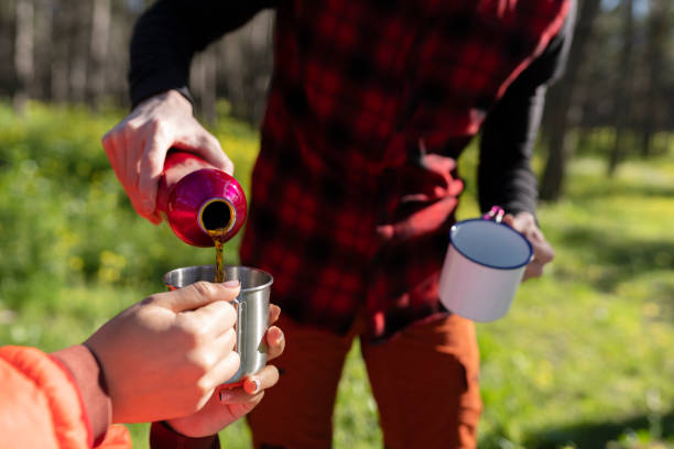 istock Pouring Hot Drink Outdoors in Forest 2153771710