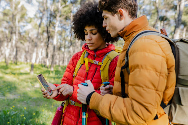 istock Couple Using GPS on Smartphone for Hiking Navigation 2153771756