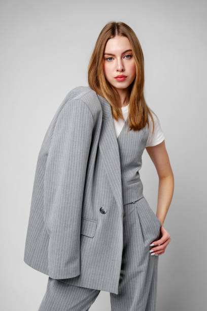 istock Woman in Gray Suit and White Shirt posing in studio 2153772289