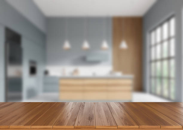 istock Wooden countertop on background of kitchen interior with window. Mockup 2153773347