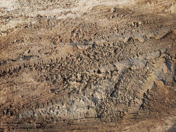 istock Wheel tracks on the soil road background or texture 2153774735