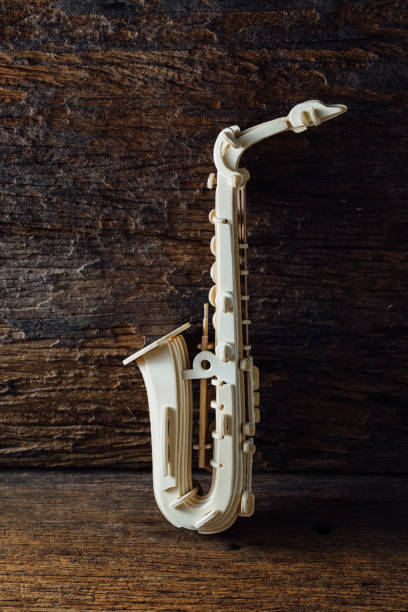 istock saxophone wood on wooden background 2153775942