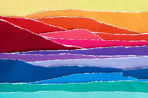 Abstract artistic collage from torn paper elements. Gradient colors. Mountain ocean shore landscape in golden hour. Making art from used pieces.