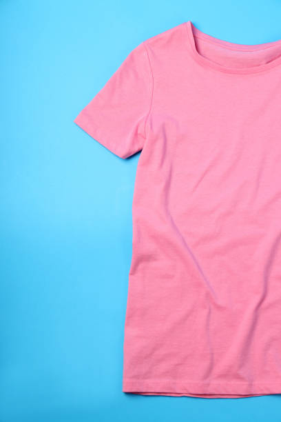 istock Blank pink t-shirt with space for print on blue background 2153778896