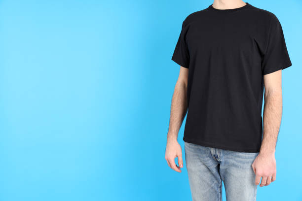 istock Man in blank black t-shirt on blue background 2153778943