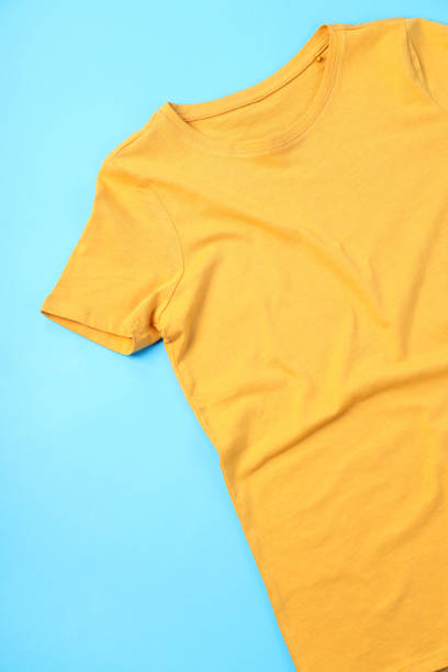 istock Blank yellow t-shirt with space for print on blue background 2153778975
