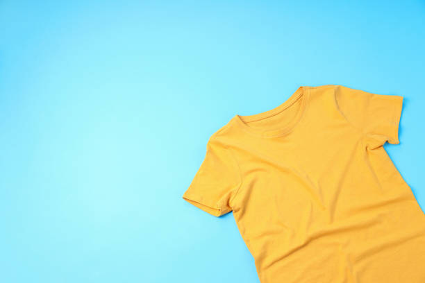 istock Blank yellow t-shirt with space for print on blue background 2153779122