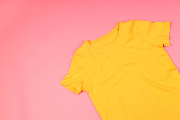 istock Yellow t-shirt with space for print on pink background 2153779185