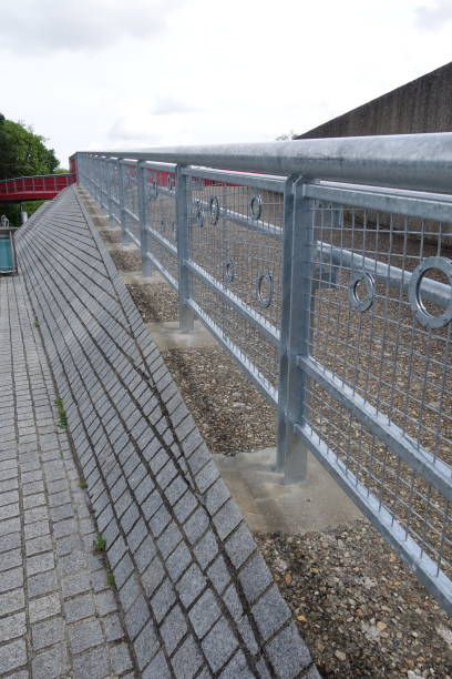 istock Stainless steel railing on a sloping pedestrian path  Pedestrian path leading to a bridge 2153779717