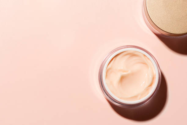 Open jar of pink peach beauty cream