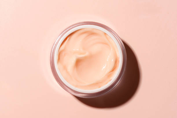 istock Open jar of pink peach beauty cream 2153780286