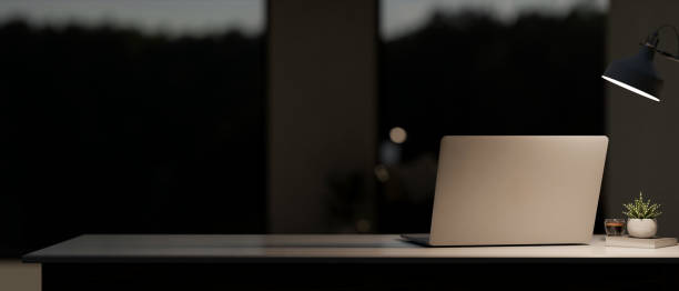 istock A back view image of a laptop computer on the table in a modern, dark room at night. 2153781016