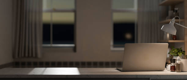 istock A home office workspace with a laptop computer on a table in the room in the evening. 2153781021