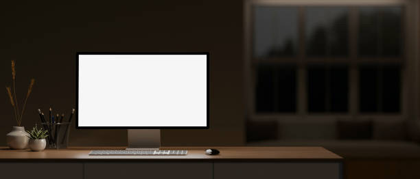 istock A comfortable home office workspace at night features a computer mockup on a table in the dark room. 2153781043