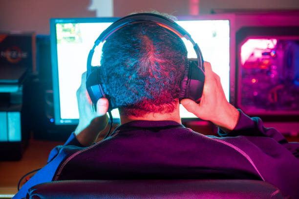 istock A gamer adjusting his headset, preparing for an immersive gaming session 2153781783