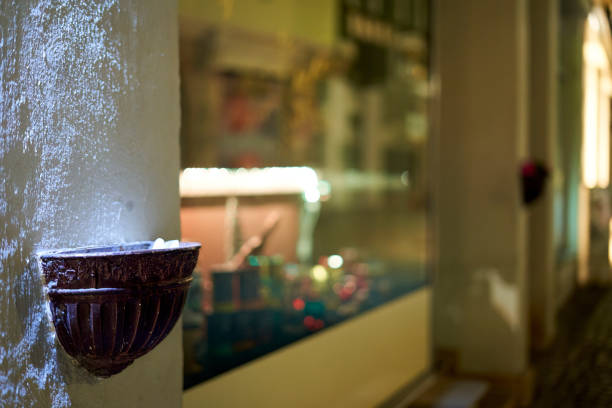 Ornament on a facade. Illuminated trough on a building in front of reflection in the window.