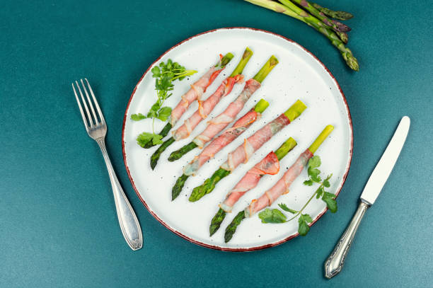 Young green asparagus baked in bacon. Top view.