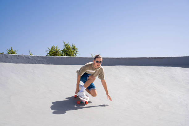 istock Man Riding Skateboard Down Ramp 2153783979