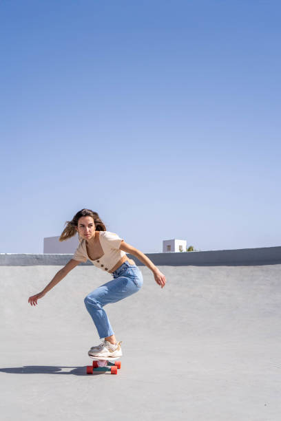istock Confident woman riding skateboard in skate park 2153785681