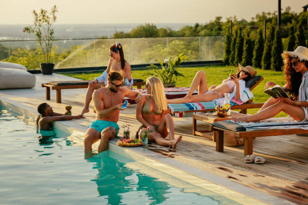 istock Friends enjoying a sunny day by the pool 2153788294