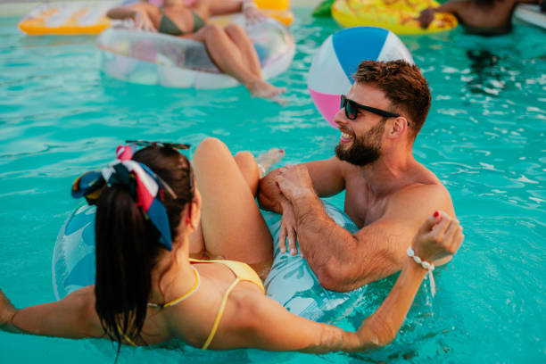 istock Couple chilling in the pool on a sunny day 2153788333