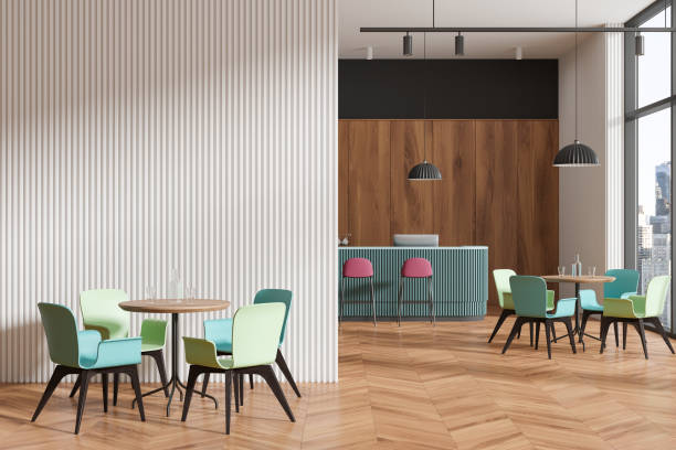 istock A modern cafe interior with colorful chairs, wooden tables, panoramic windows, and striped wall panels, light. 3D Rendering 2153789656