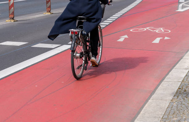Germany, Berlin,  Schöneberg, April 11, 2024 -Low section of bicycle rider on bicycle lane