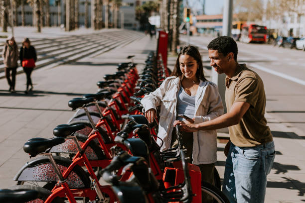 istock Intimate moment shared between a couple selecting public bicycles in sunny Barcelona 2153790541