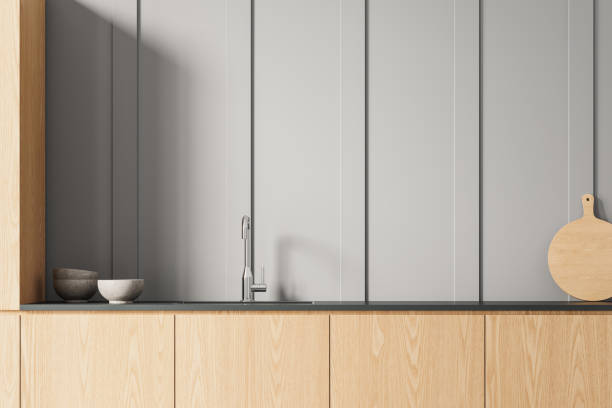 Stylish home kitchen interior with washbasin and stove, minimalist kitchenware