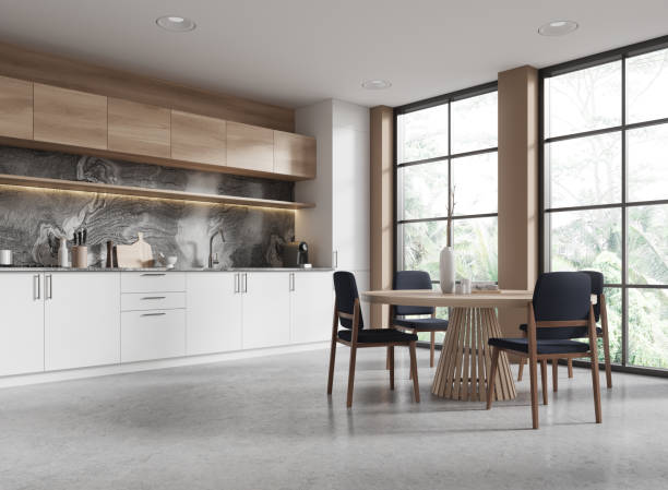 istock Stylish home kitchen interior with dining and cooking space, panoramic window 2153791568