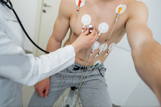 A patient undergoing a cardiac test with electrodes attached to their chest.